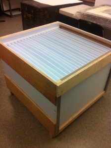 Fluted plastic (Coroplast or Correx) with a frame of wood makes good in-house temporary storage for framed art.